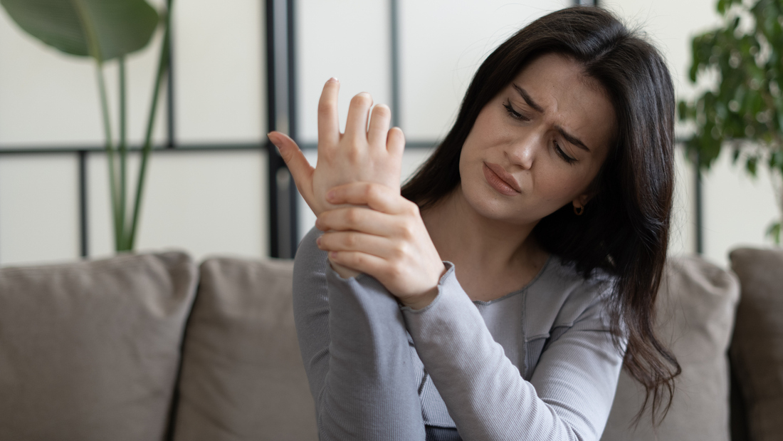 Woman holding wrist in pain.jpg