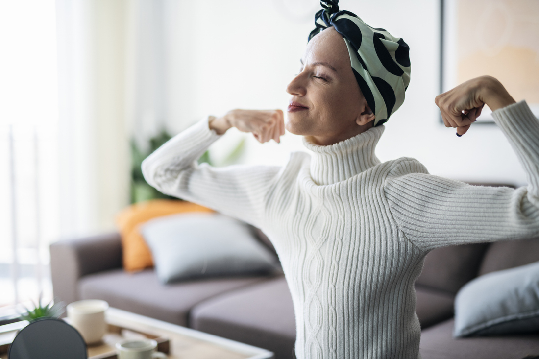 Cancer patient flexing arms.jpg