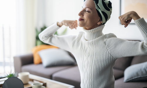 Cancer patient flexing arms.jpg