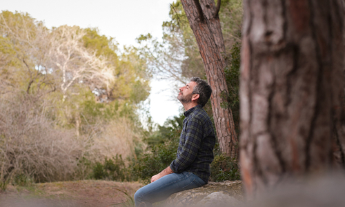 Man sitting outside breathing fresh air.jpg