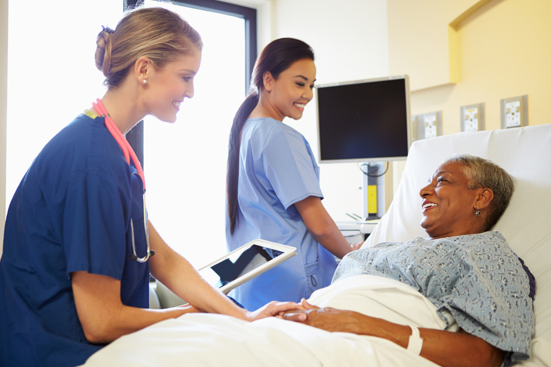 Nurses prepping female hospital patient.jpg