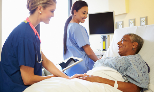 Nurses prepping female hospital patient.jpg