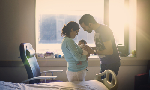 new parents holding baby