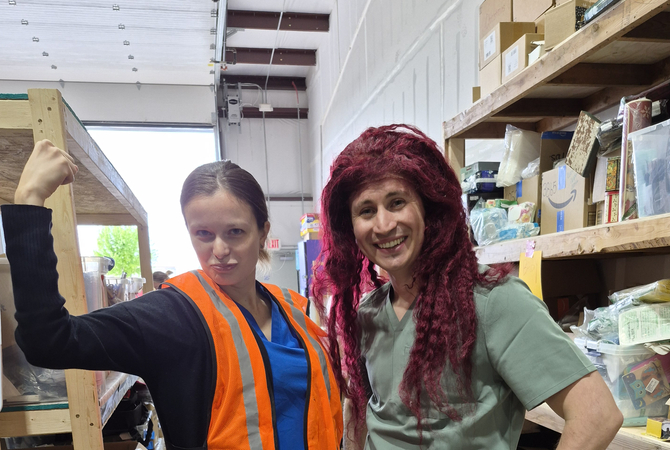 Residents at a community service event trying on a wig and orange vest..jpg