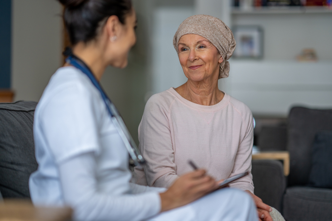 Cancer patient with head scarf talking to doctor.jpg