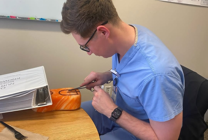 Family Medicine resident practicing stitching.jpg