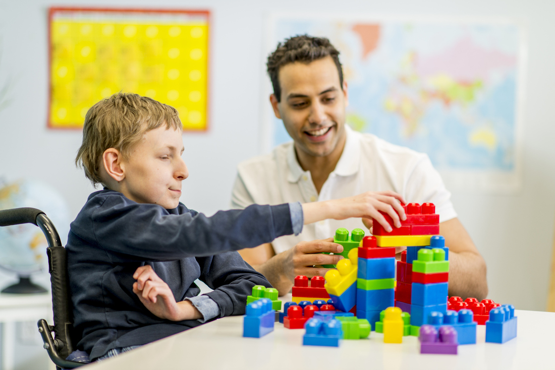 Volunteer playing with special needs child.jpg