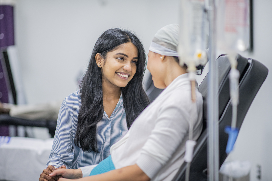 Woman supporting loved on getting infusion therapy.jpg