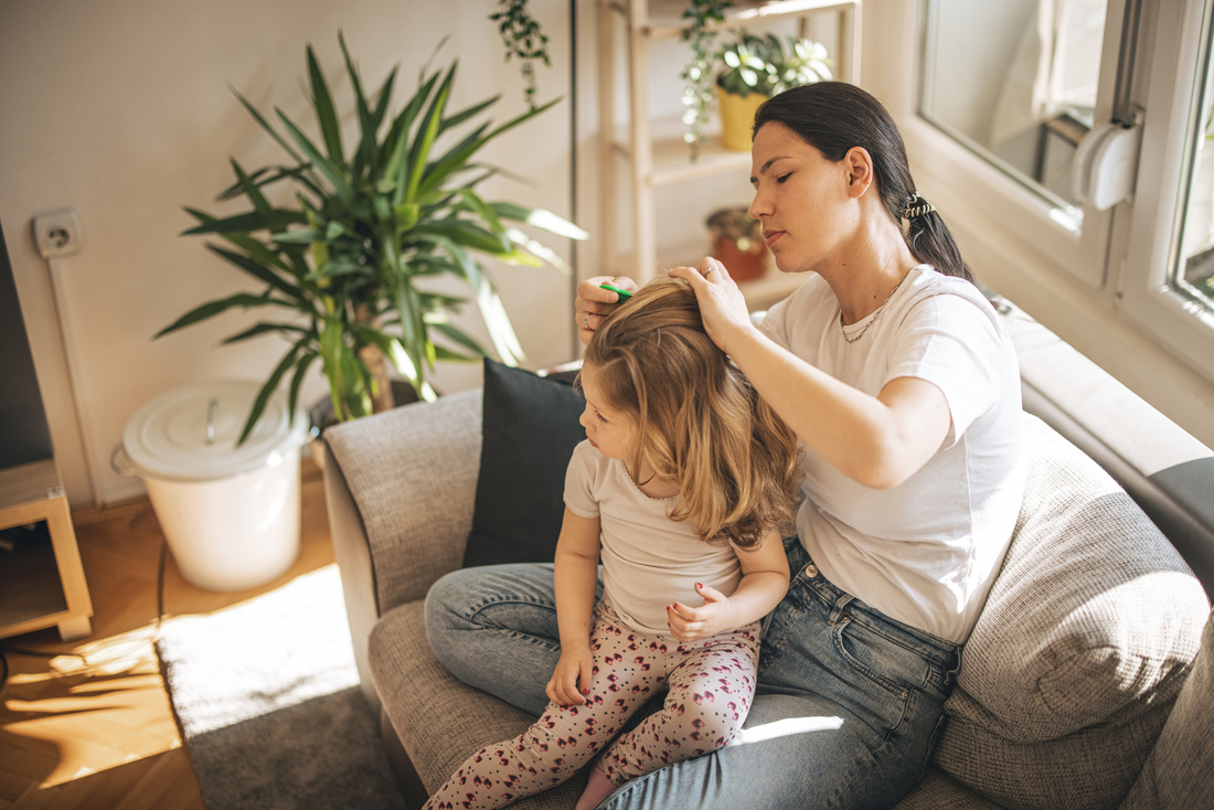 Woman treating childs lice.jpg