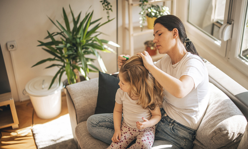 Woman treating childs lice.jpg