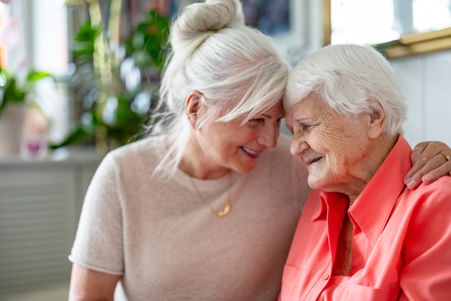 Smiling senior woman sitting with daughter