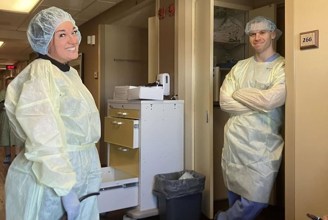 Two Family Medicine Residents in isolation gowns smiling at camera.jpg