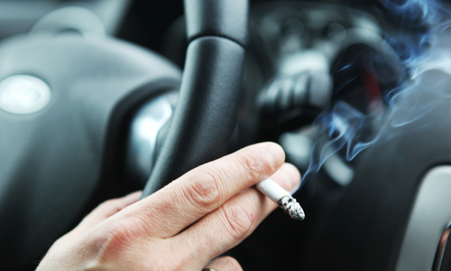 Holding cigarette in car.jpg