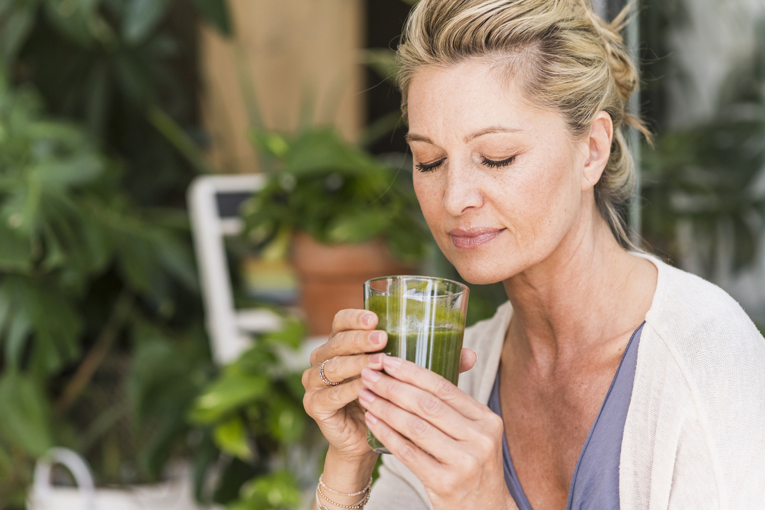 Woman holding healthy green smoothie.jpg