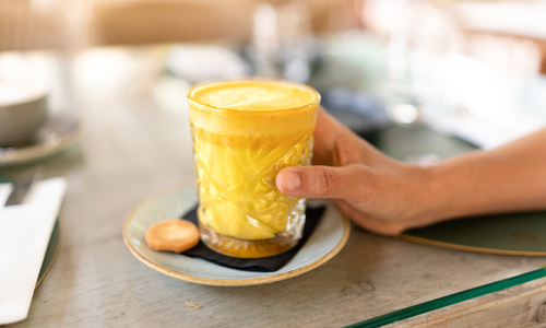 Woman holding turmeric latte.jpg