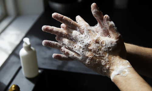 Person washing hands with soap.jpg