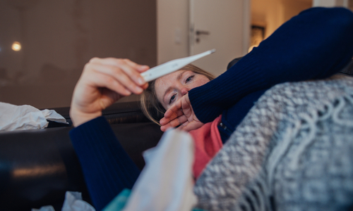 Sick woman reading thermometer.jpg