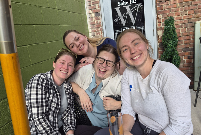 A group of residents at a restaurant smiling at the camera..jpg