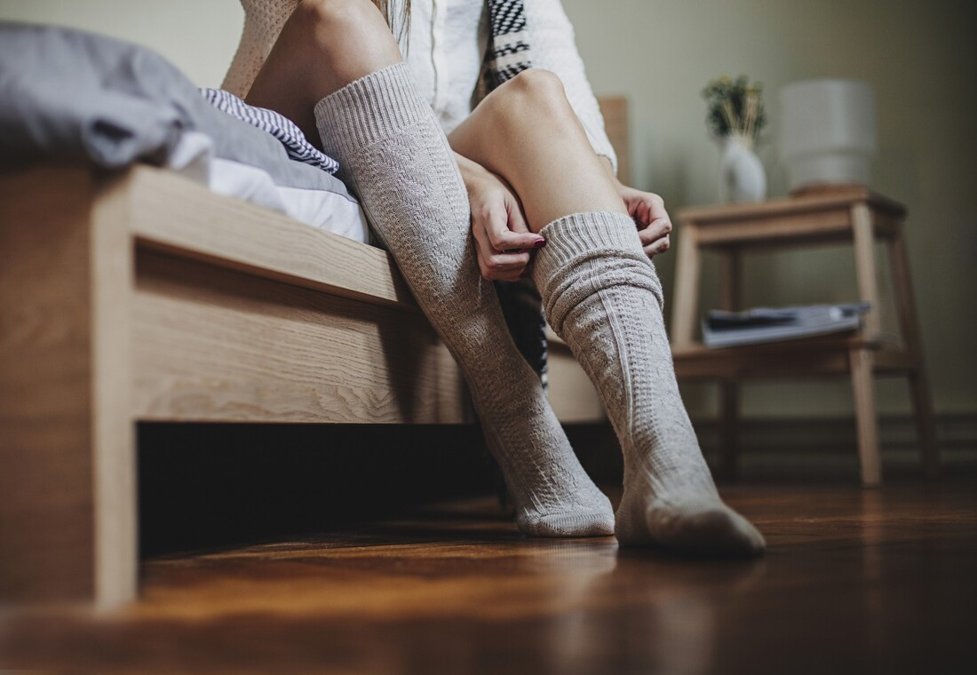 Woman putting on thick socks.jpg