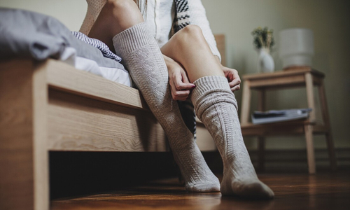 Woman putting on thick socks.jpg