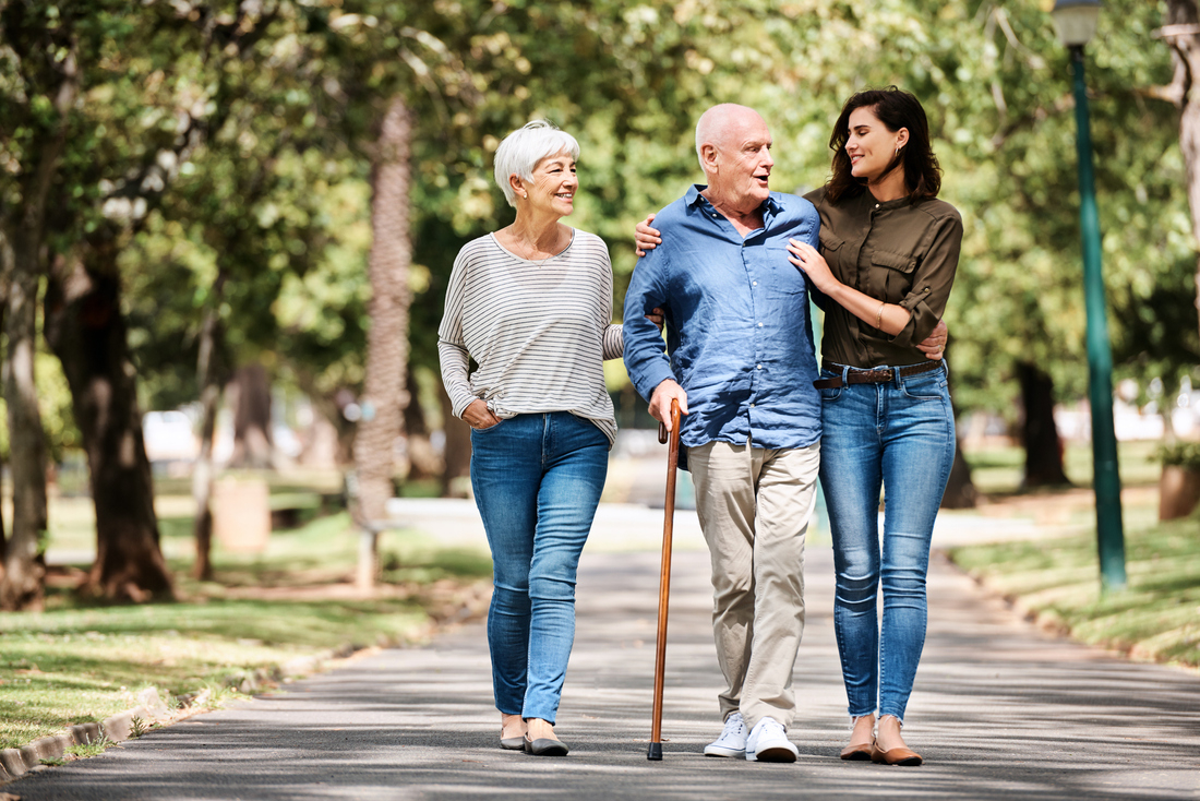 Senior walking outdoors with cane.jpg