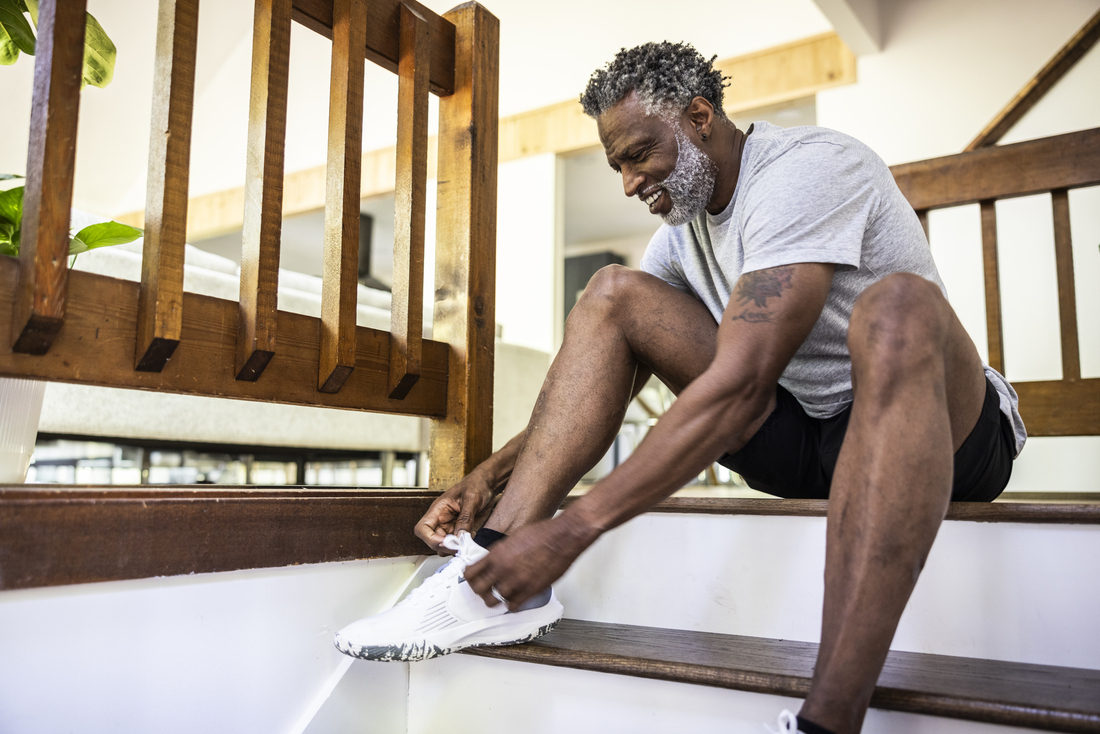 Senior man putting on running shoe.jpg