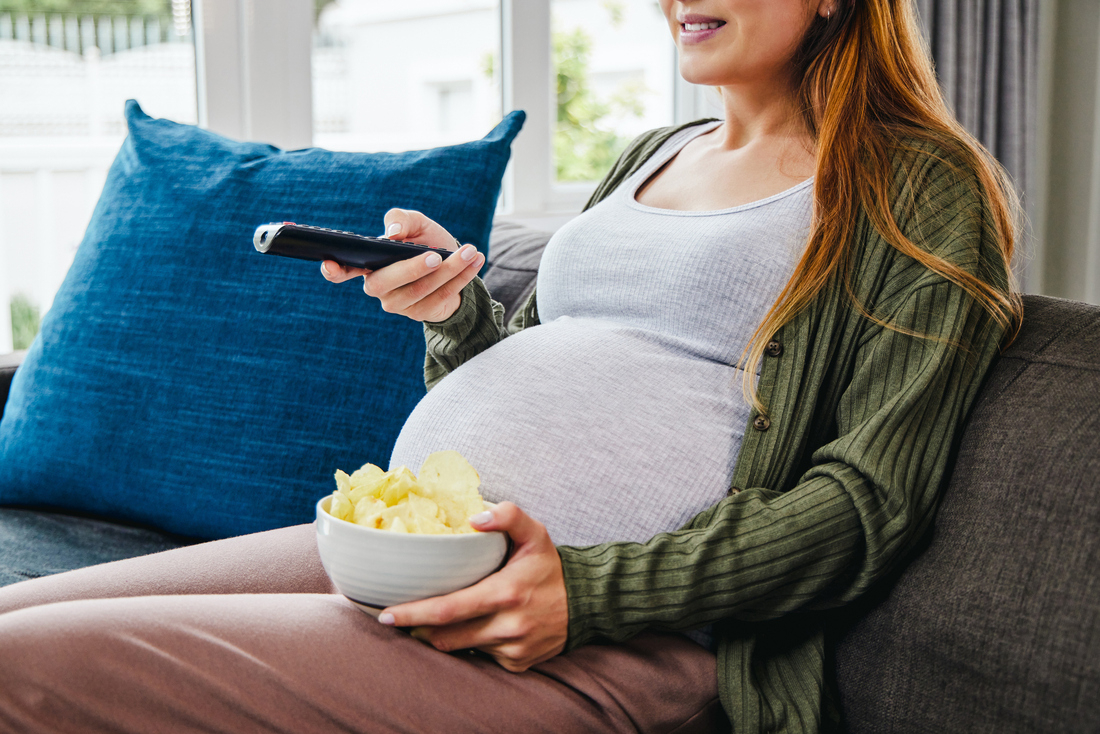 Pregnant woman eating chips.jpg