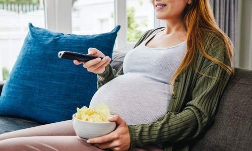 Pregnant woman eating chips.jpg