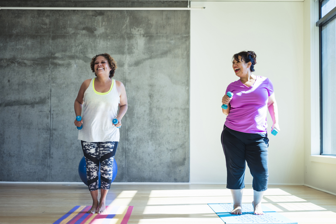 Two women working out with dumbells.jpg