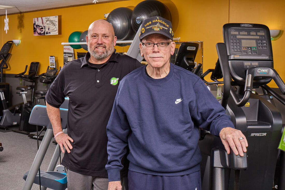 Kurt and Allen Buck standing in room of fitness equiment.jpg