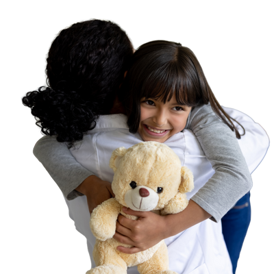 Child hugging doctor and holding teddy bear