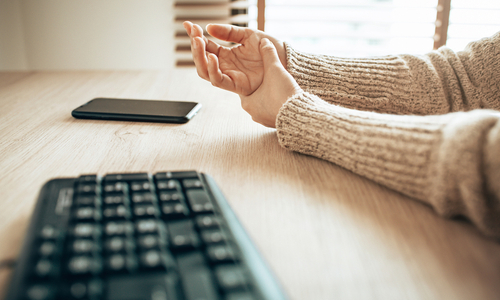 Woman rubbing numb hand.jpg
