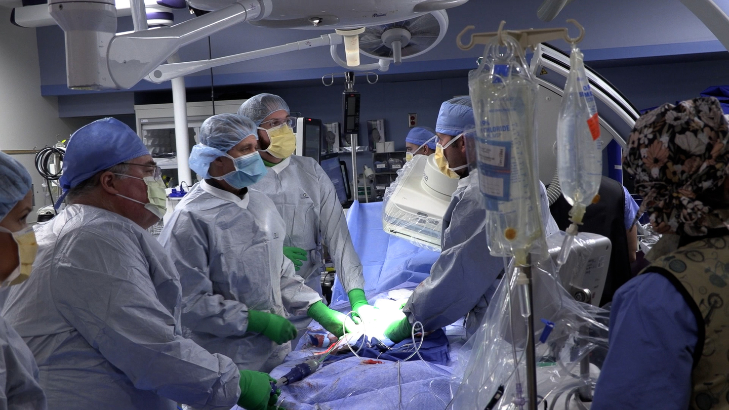 Healthcare workers perforing procedure in operating room