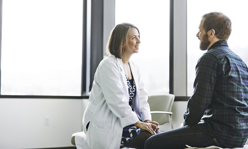 Female doctor talking to male patient.jpg