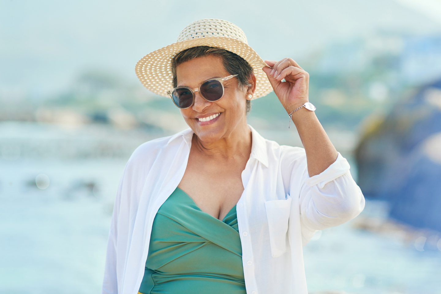 woman smiling standing alone during a day out on the beach