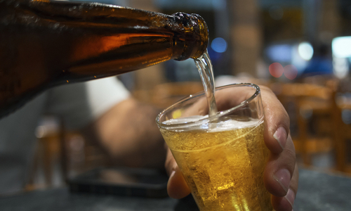 Pouring beer into a cup.jpg