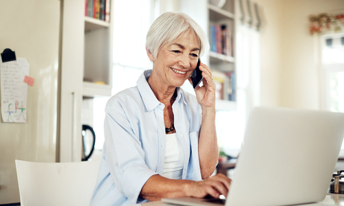 Woman speaking on phone with open laptop.jpg