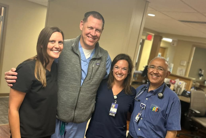 A group of faculty in clinic smiling at the camera..jpg