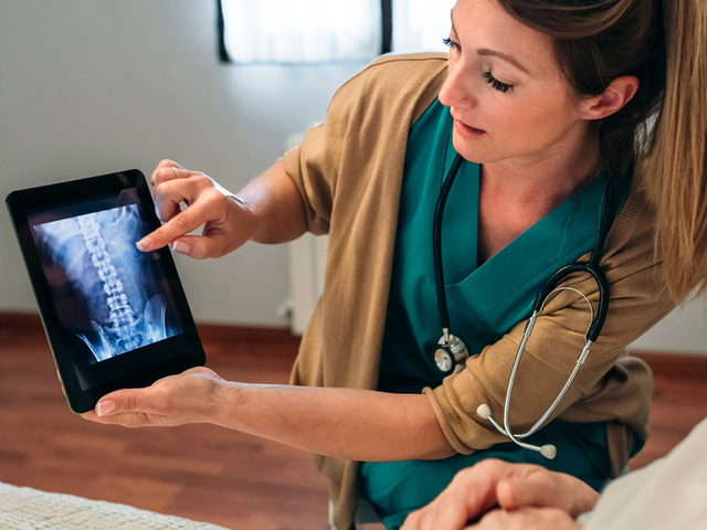 Orthopedic doctor showing bone x-ray to patient.jpg
