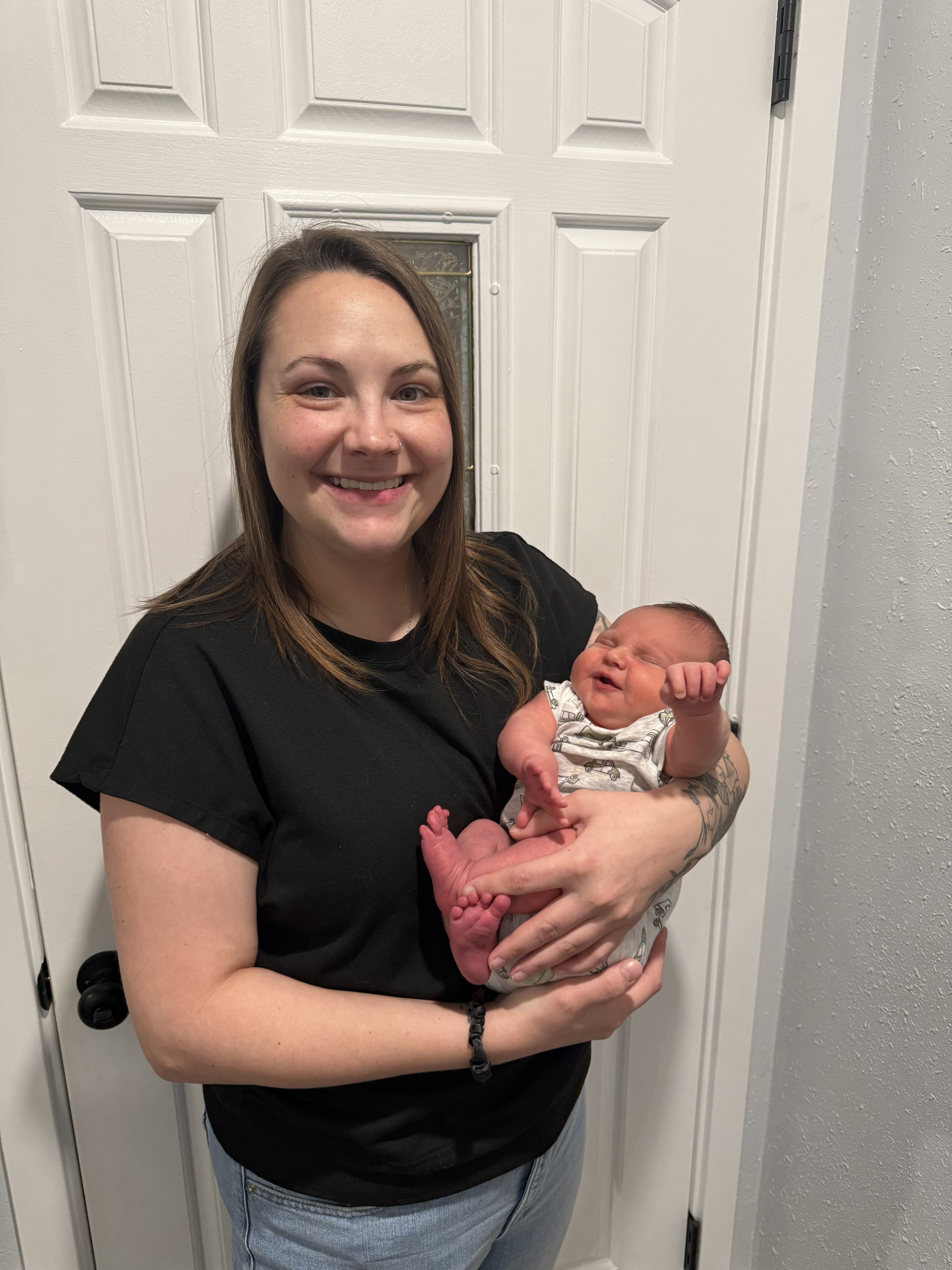 Person holding a newborn baby indoors.jpg