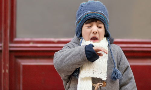Child outside in the cold sneezing.jpg