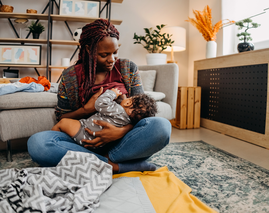 Mother breastfeeding baby at home.jpg