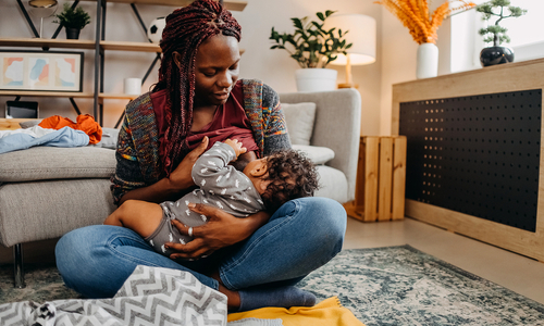 Mother breastfeeding baby at home.jpg
