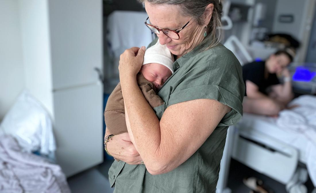 Grandma at hospital holding infant
