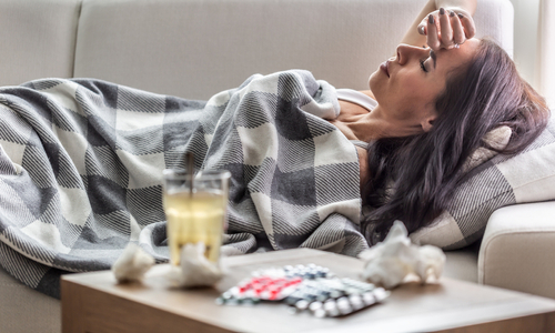 Sick woman lying on couch.jpg