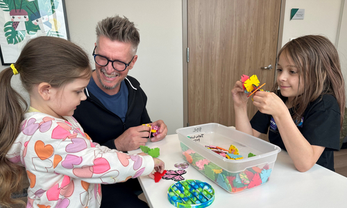 Children playing at table with provider