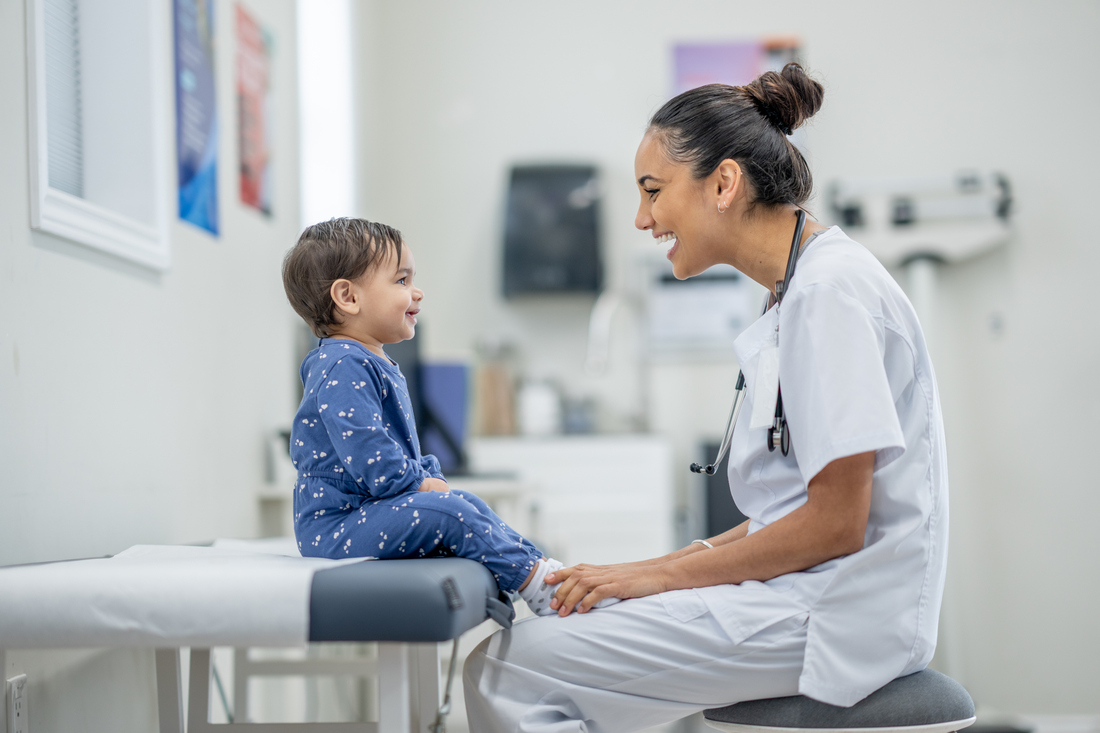 Happy doctor with pediatric patient.jpg