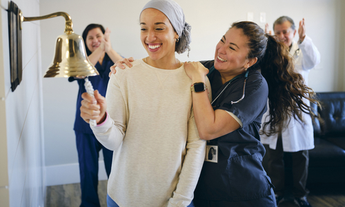 Happy cancer patient ringing bell.jpg