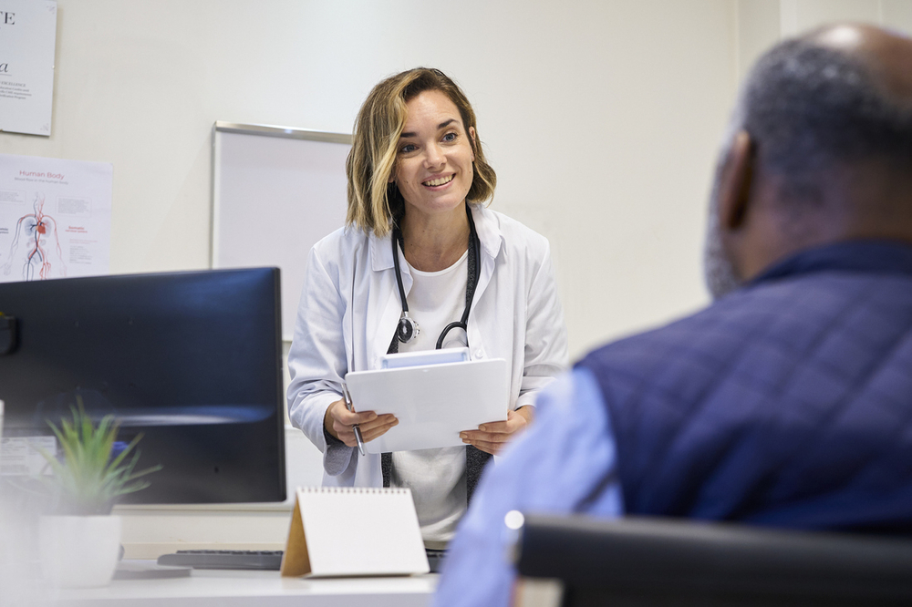Happy doctor talking to patient.jpg