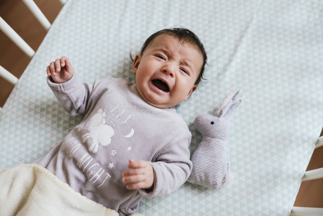 Baby crying in bed.jpg